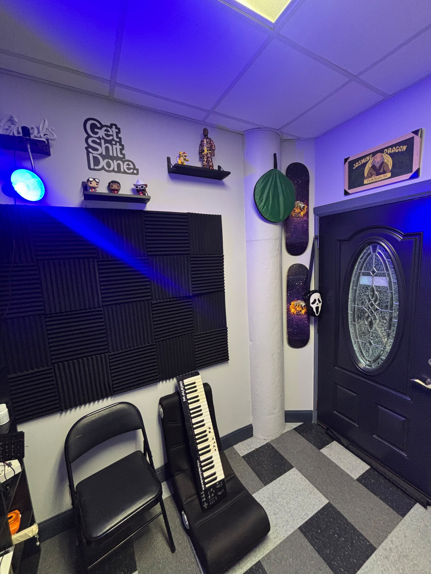 Studio B acoustic treatment wall with keyboard and blue lighting