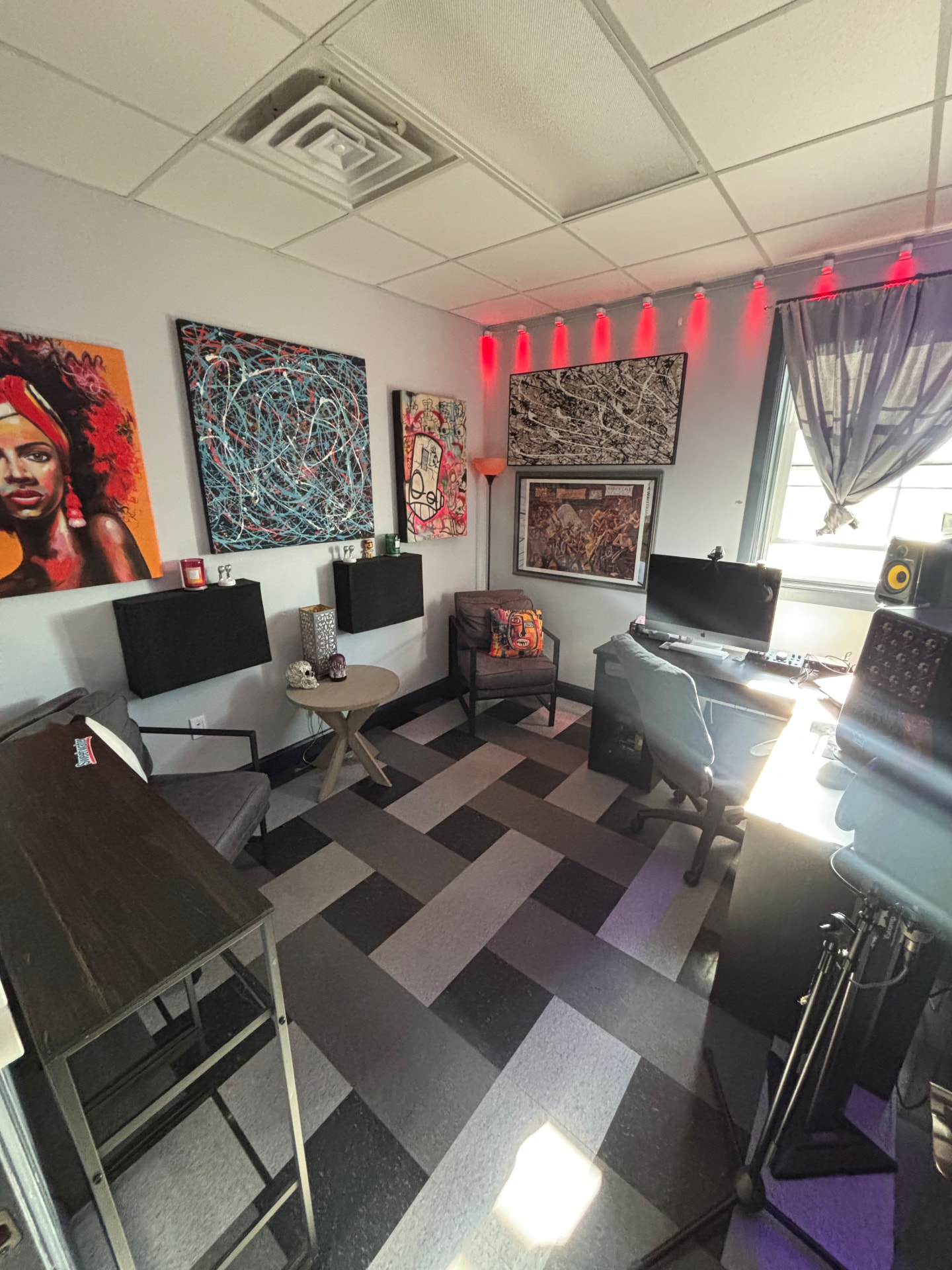 Studio B seating area and desk under red lighting